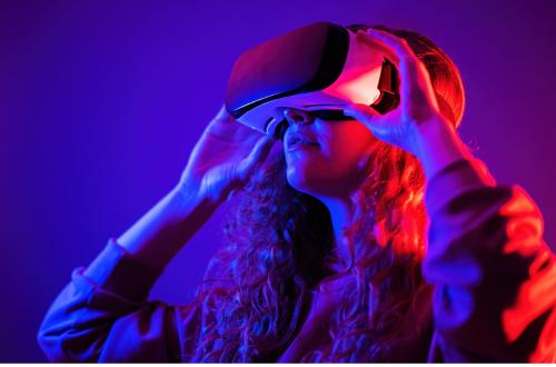 A young woman uses a virtual reality (VR) headset for learning and development.