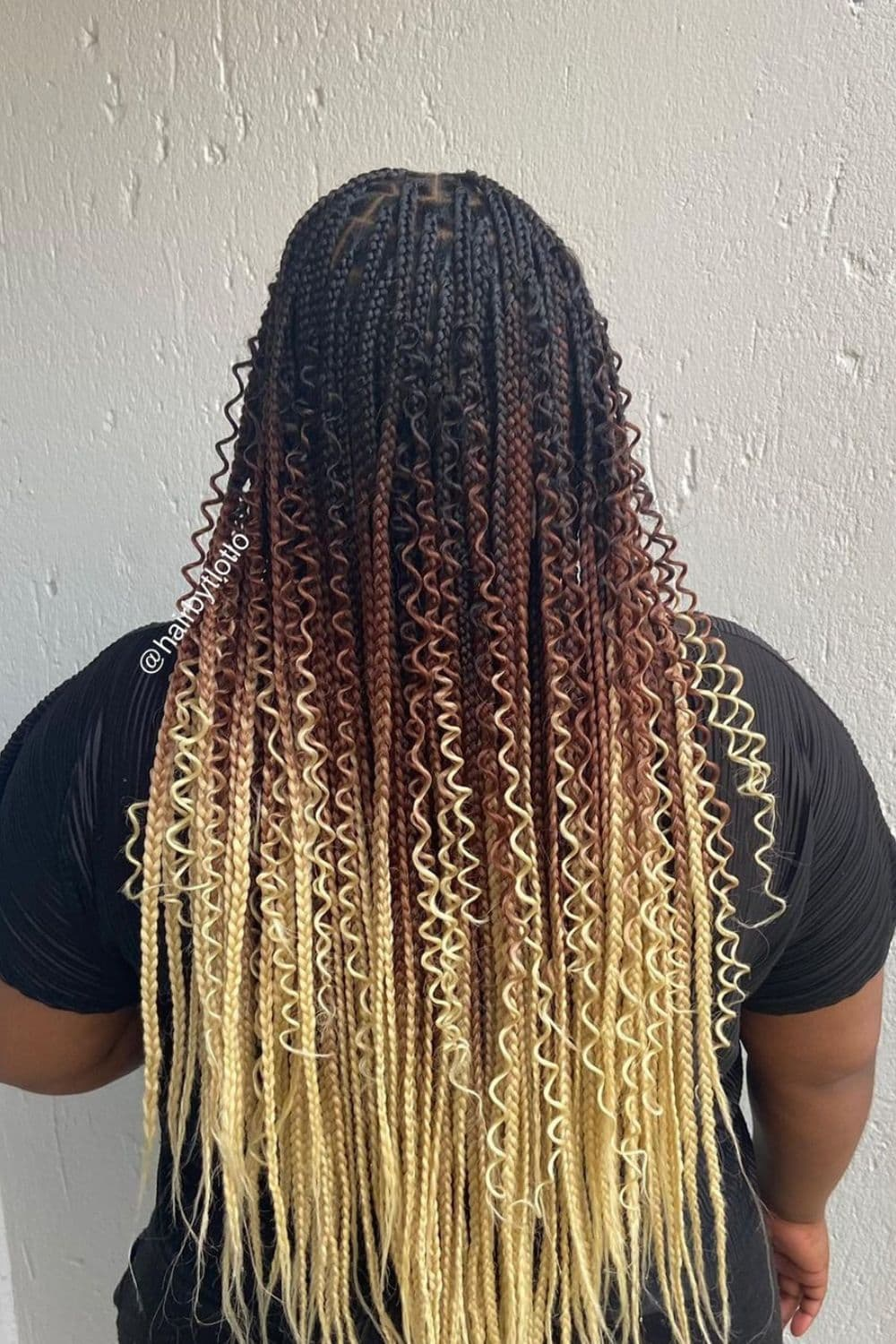 Back view of a lady wearing the blond ombre goddess braids