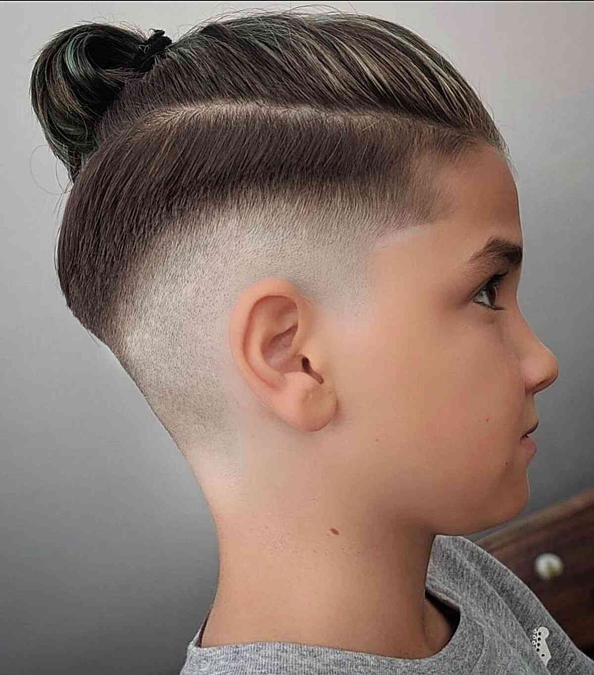 Boys haircut: picture of a boy rocking the man bun style