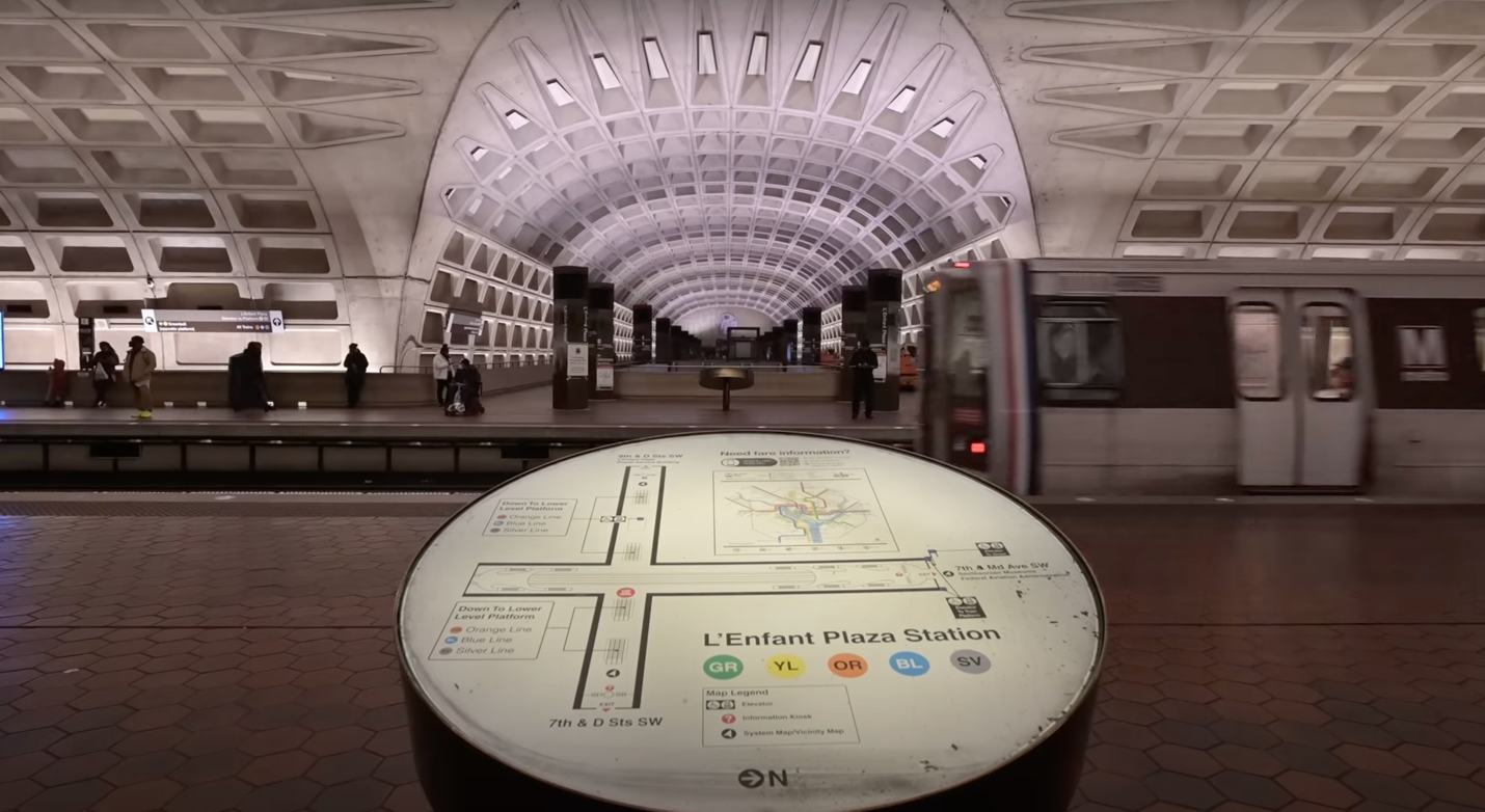 A circular table with a map in the middle of a train station

Description automatically generated