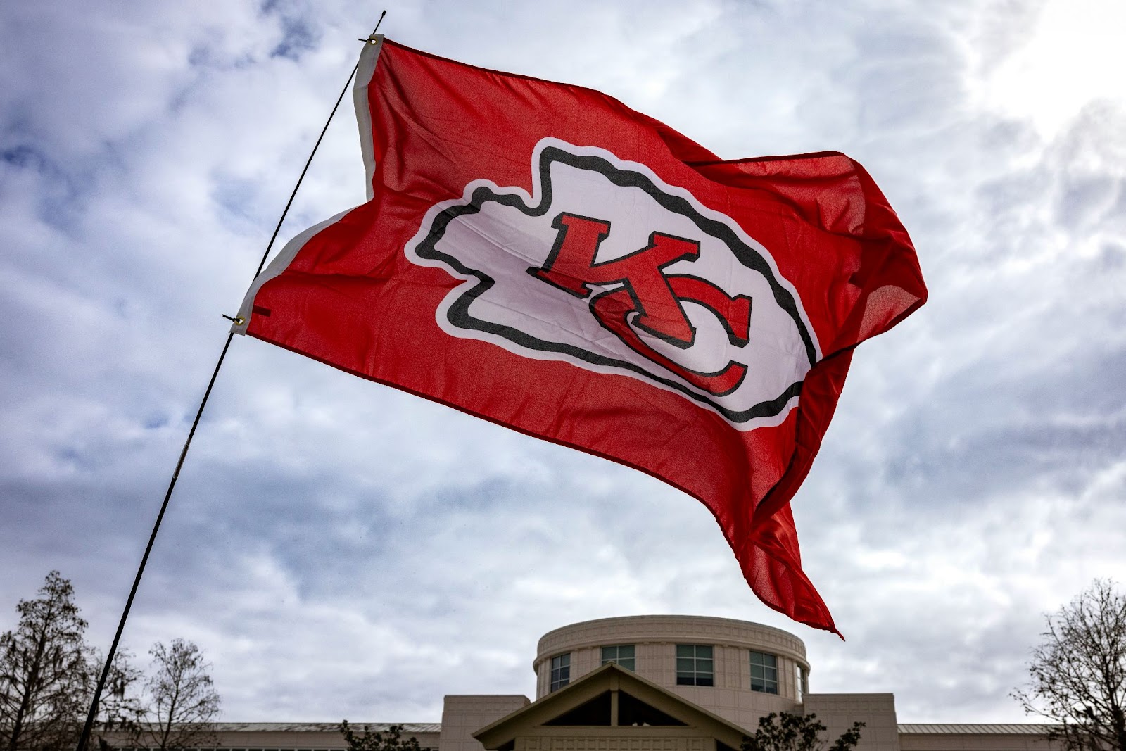 Kansas Chiefs flag flying in front of a building