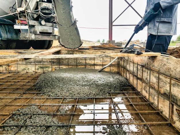 Pouring the foundation with concrete at the construction site Monolithic reinforced concrete works during the construction of the building