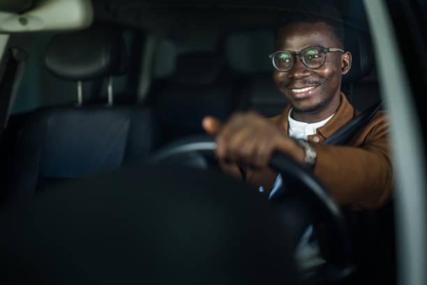happy african american businessman driving his car. - black man with car stock pictures, royalty-free photos & images