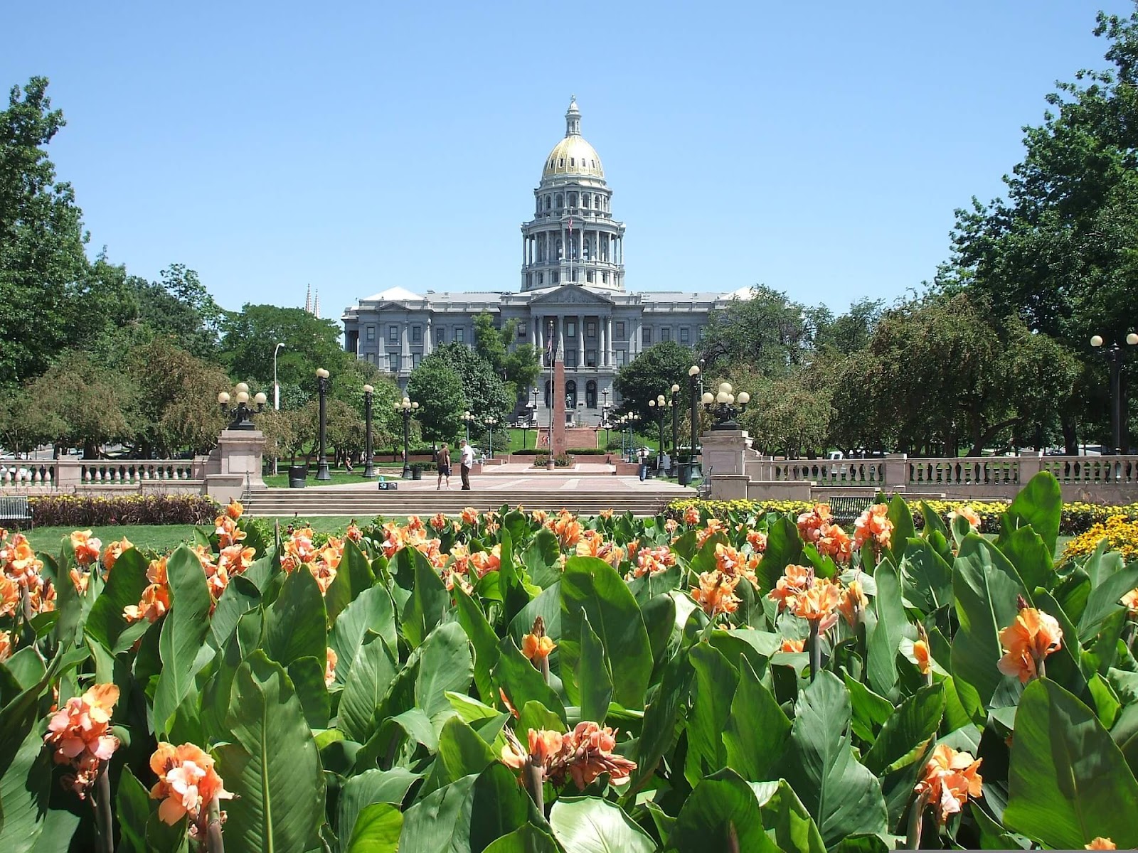 front of Colorado State Capitol building with people and flowers