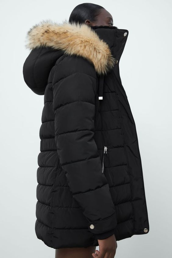 Side view of a model wearing the Moose Knuckles coat