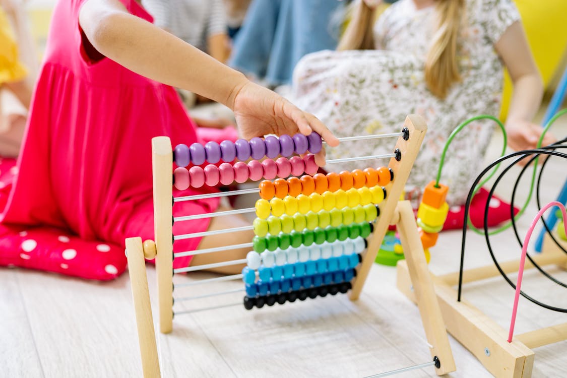 Free Girl Holding Multi Colored Wooden Abacus Stock Photo