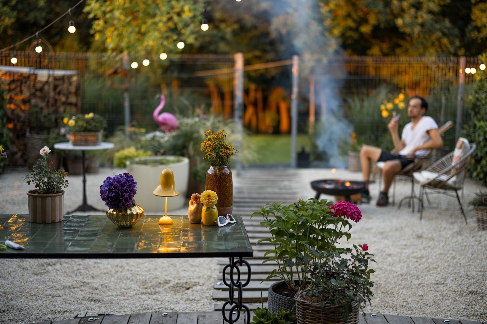 Man Sitting in Backyard Beside Fire