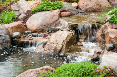 top water features to install for your outdoor living space rock waterfall in backyard custom built michigan