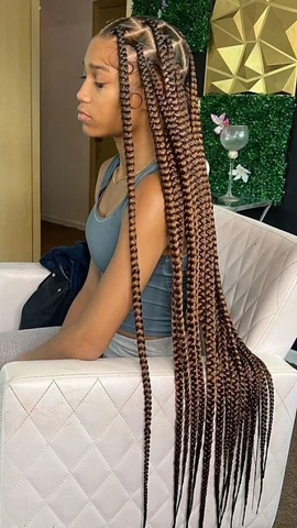 Picture of a lady wearing the  Butt-Length Brown Jumbo Box Braids