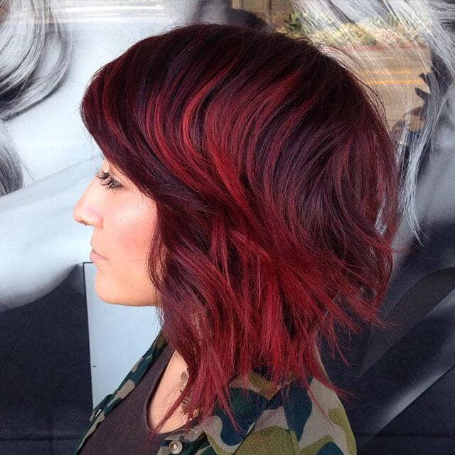 Side view of a wine colored shag haircut