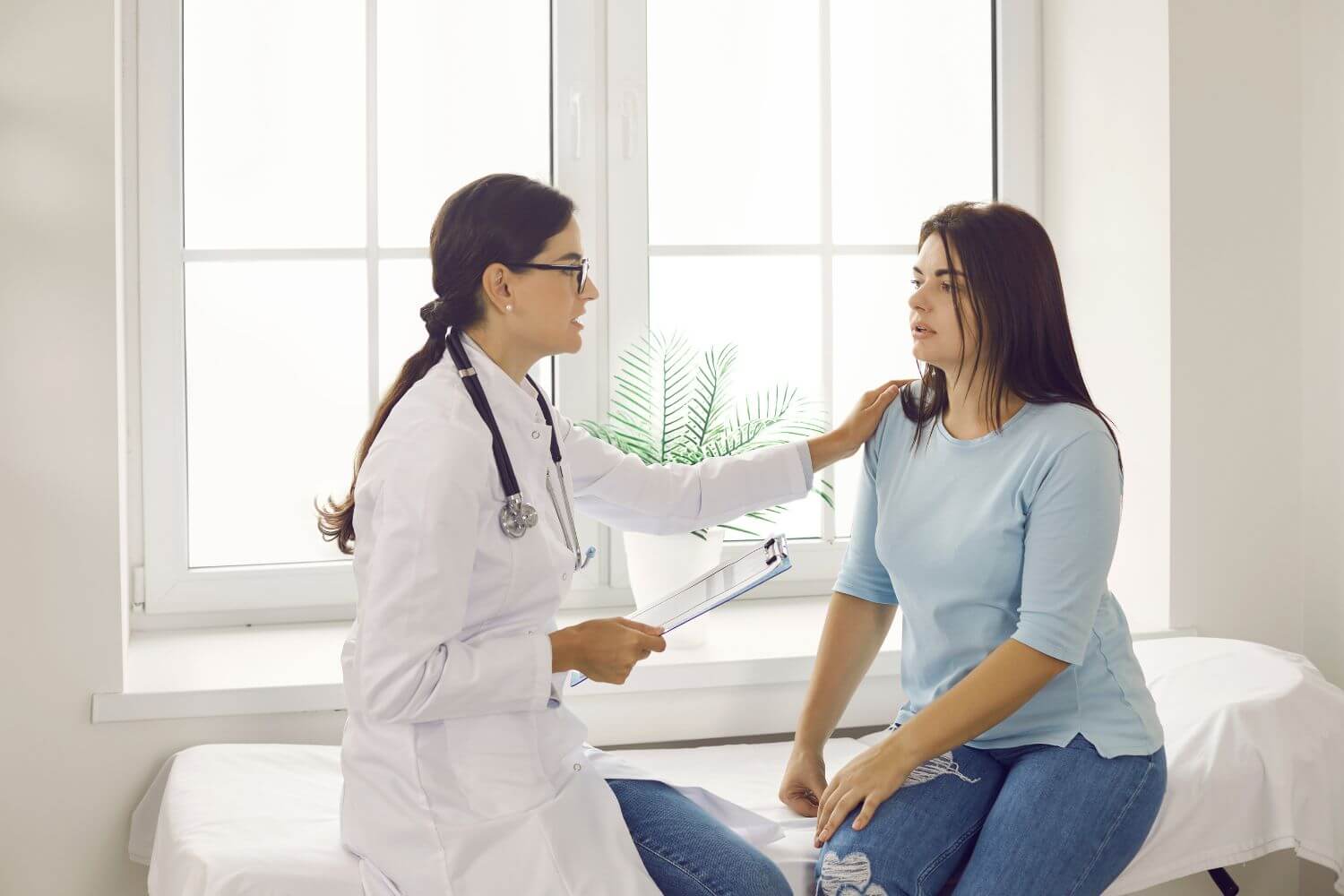 Woman speaking with a physician at a medical office