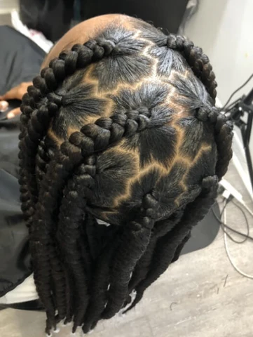 Close up view of a lady wearing the Zig-Zag Pattern Jumbo Box Braids