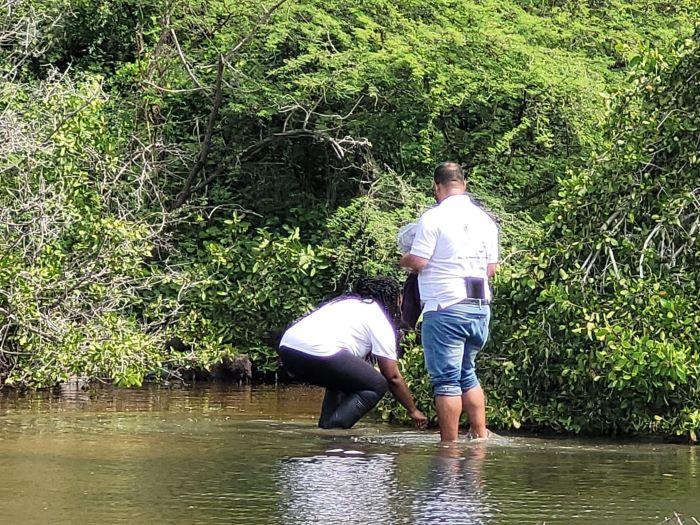 A person and person standing in water

Description automatically generated