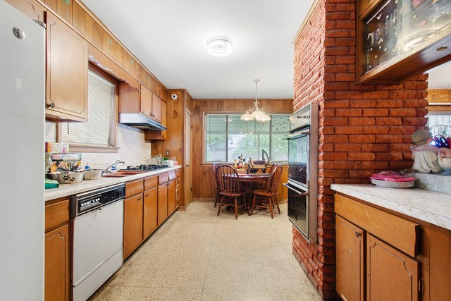 A kitchen with brick walls and a table

Description automatically generated
