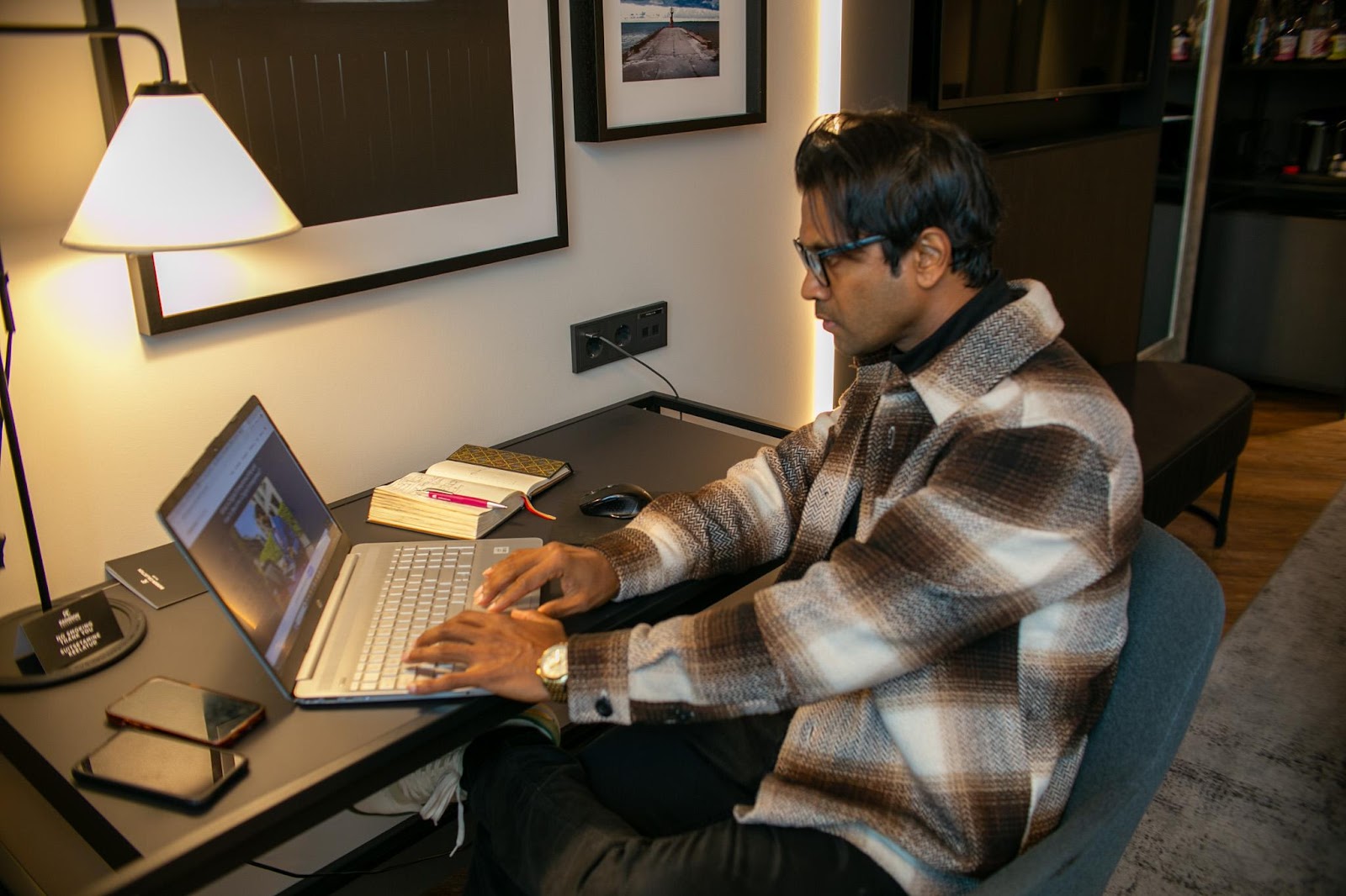 A person sitting at a desk using a computer Description automatically generated