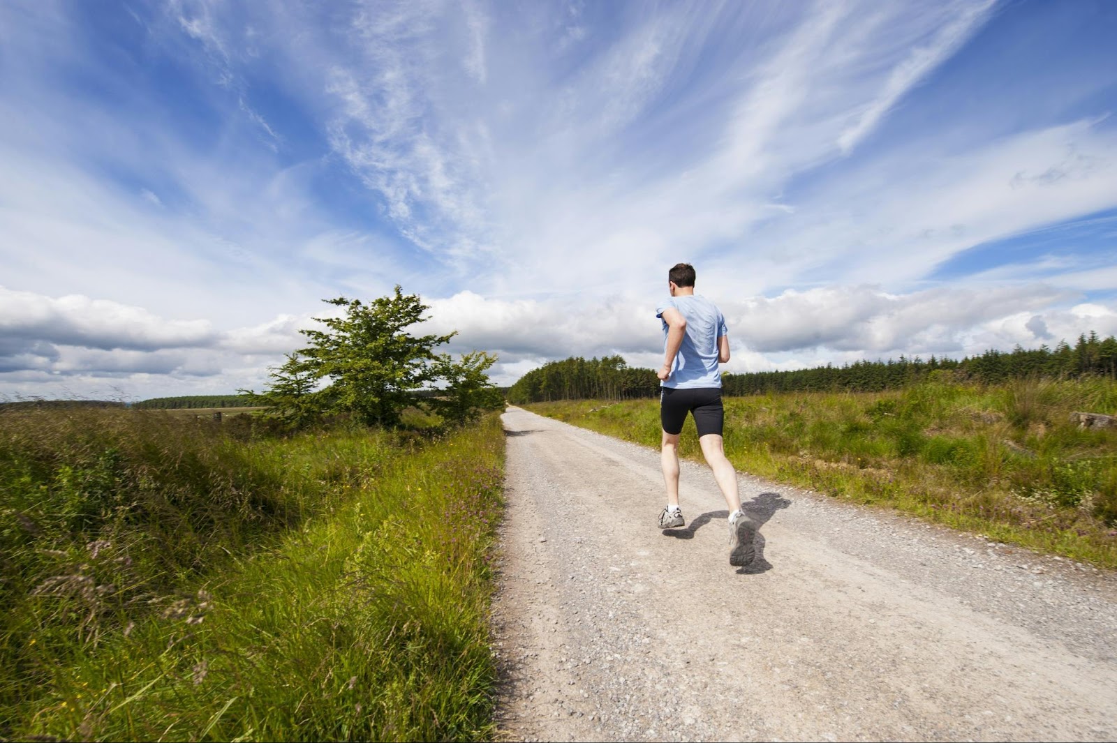 a man walking on a dirt road