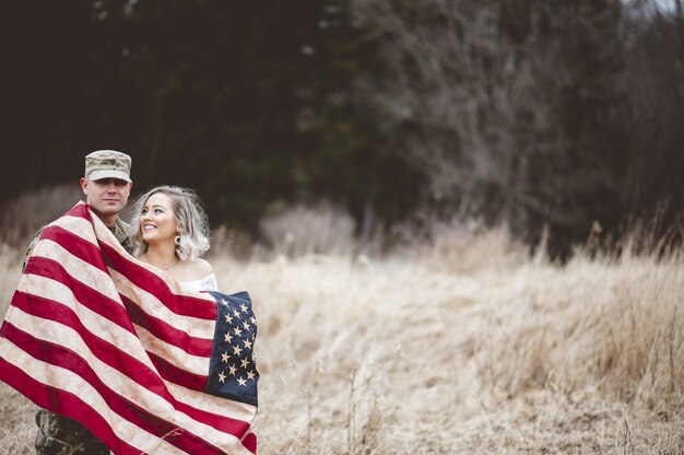 U.S. Soldier With His Smiling Wife Wrapped in American Flag