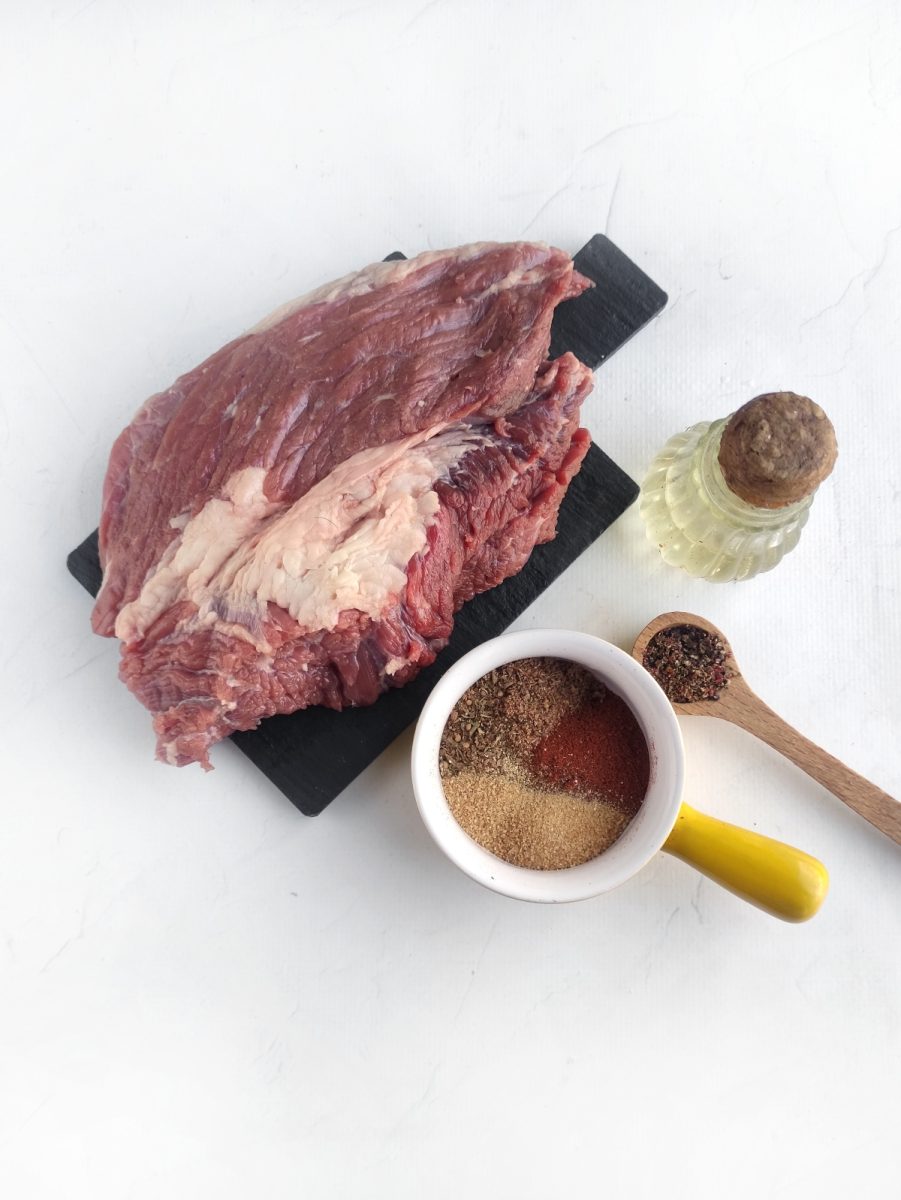 A mouthwatering air fryer ribeye steak, seasoned to perfection, is showcased on a cutting board.