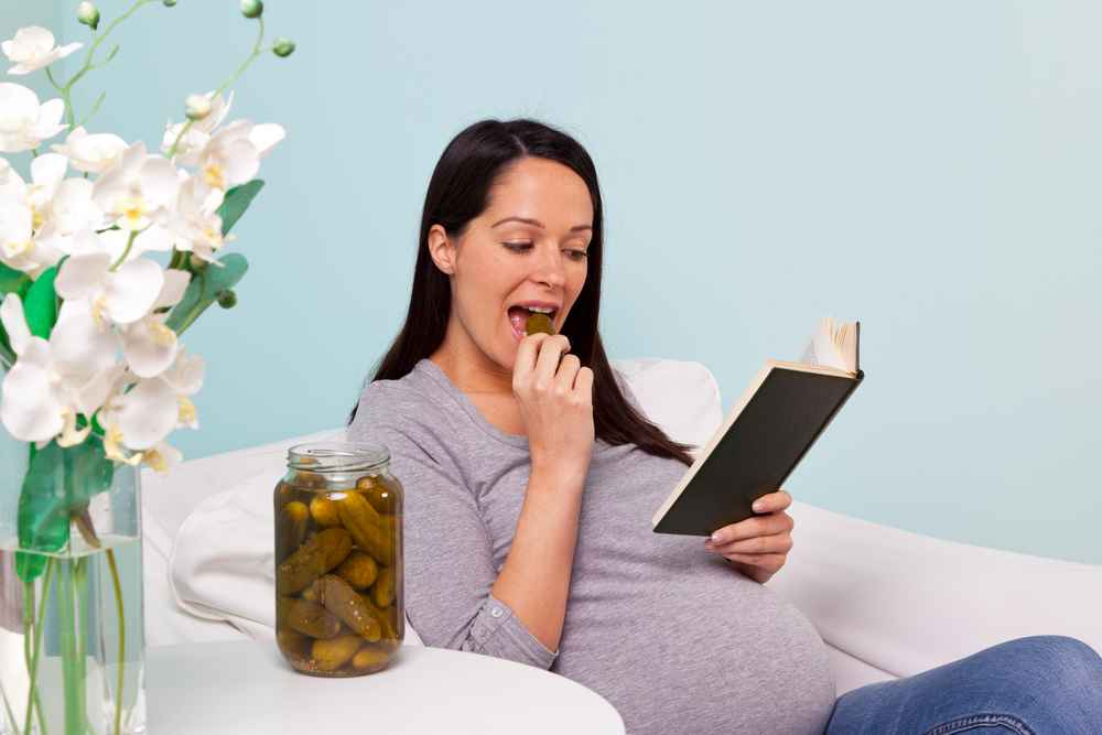 pregnant women with a jar of pickles