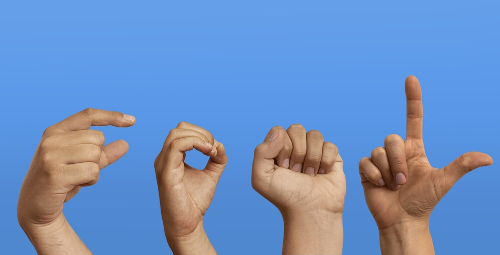 Studio shot of hands demonstrating sign language for children.