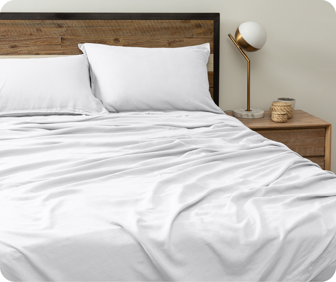 Our White Hemp Touch Sheet Set shown on a bed.