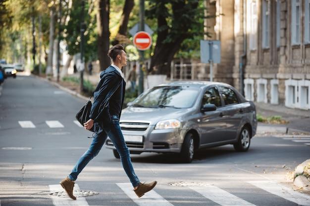 Free photo young man cross the street