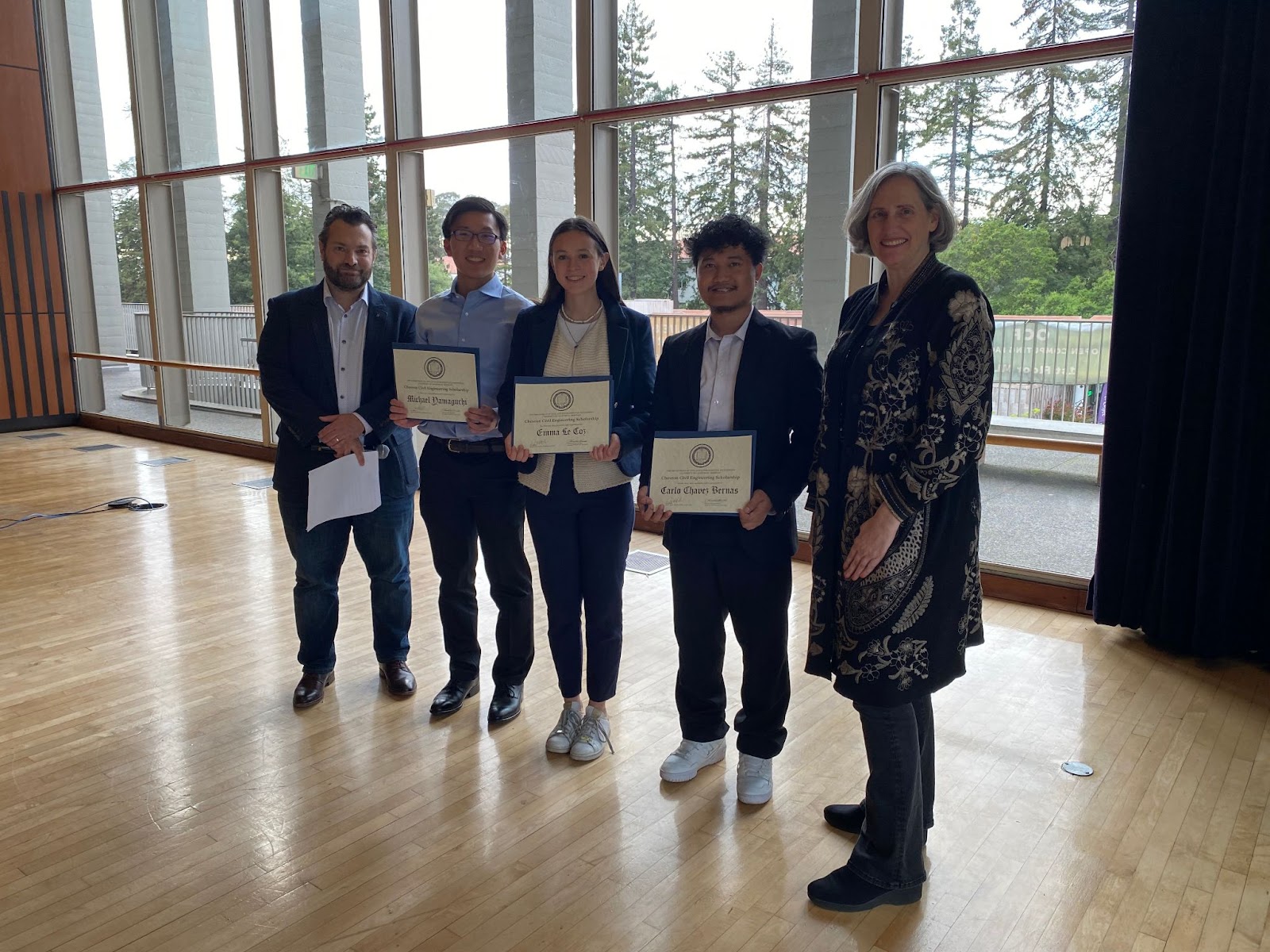 Chair Joan Walker (far right) and Dimitrios Konstantinidis (far left) present the Chevron Environmental Engineering Scholarship to Michael Yamaguchi, Emma Le Coz, and Carlo Chavez Bernas (left to right). (Photo Credit: Erin Leigh Inama).