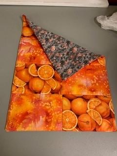 A folded oranges on a table

Description automatically generated