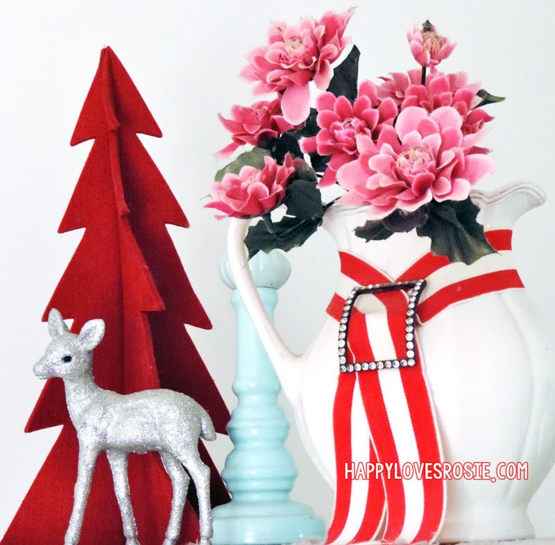 flowers in a jug with a red felt christmas tree and a silver deer