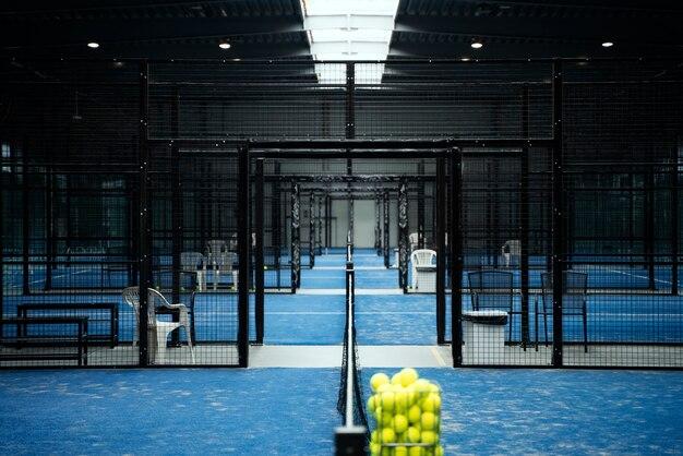 Paddle tennis field with balls in basket