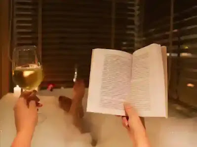 Man reading while bathing showing 5 Ways to Incorporate Wellness into Your Busy Work Schedule