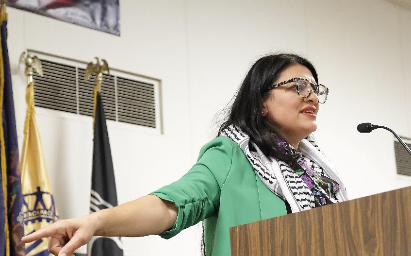 Rashida speaks at a podium