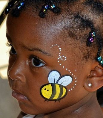 Picture of a kid with the iconic  butterfly face paint