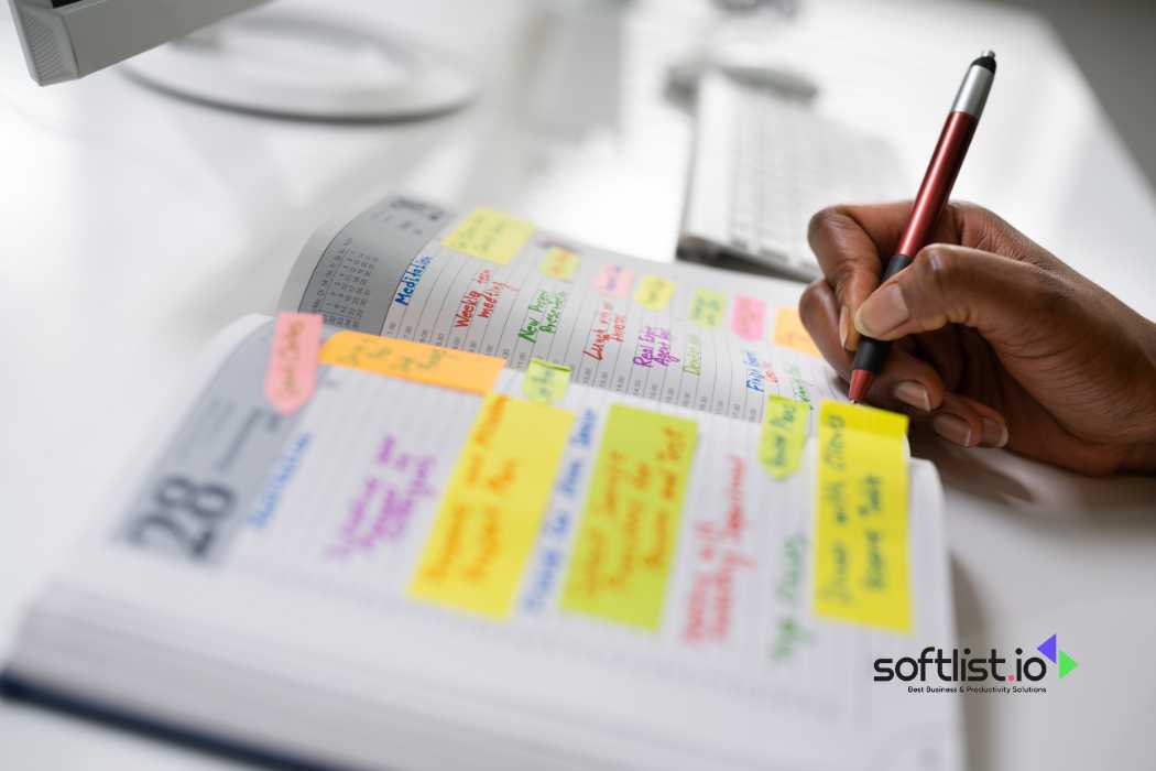 Hand writing on planner with colorful sticky notes