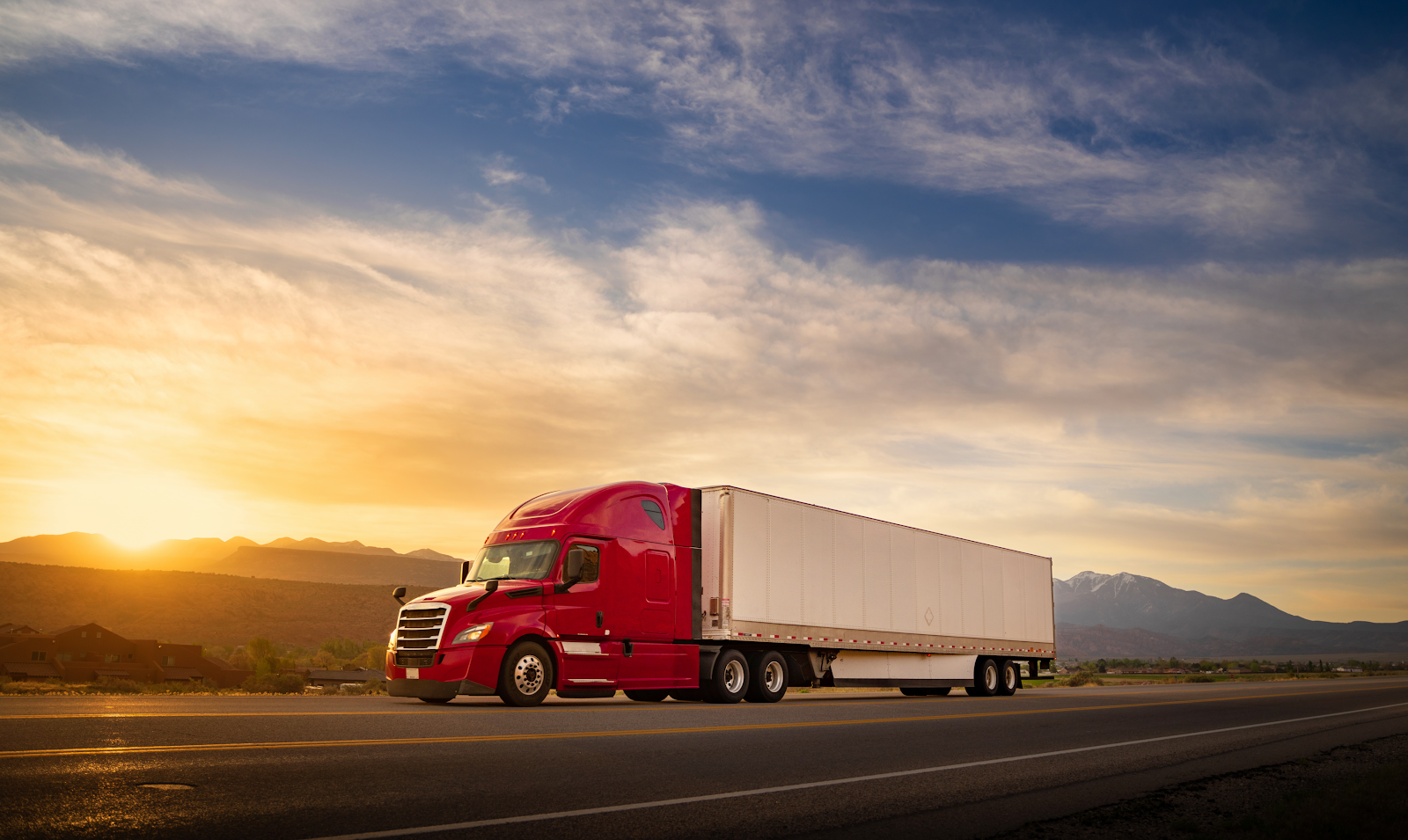 red 18 wheeler truck driving on a highway at sunset, highway safety theme