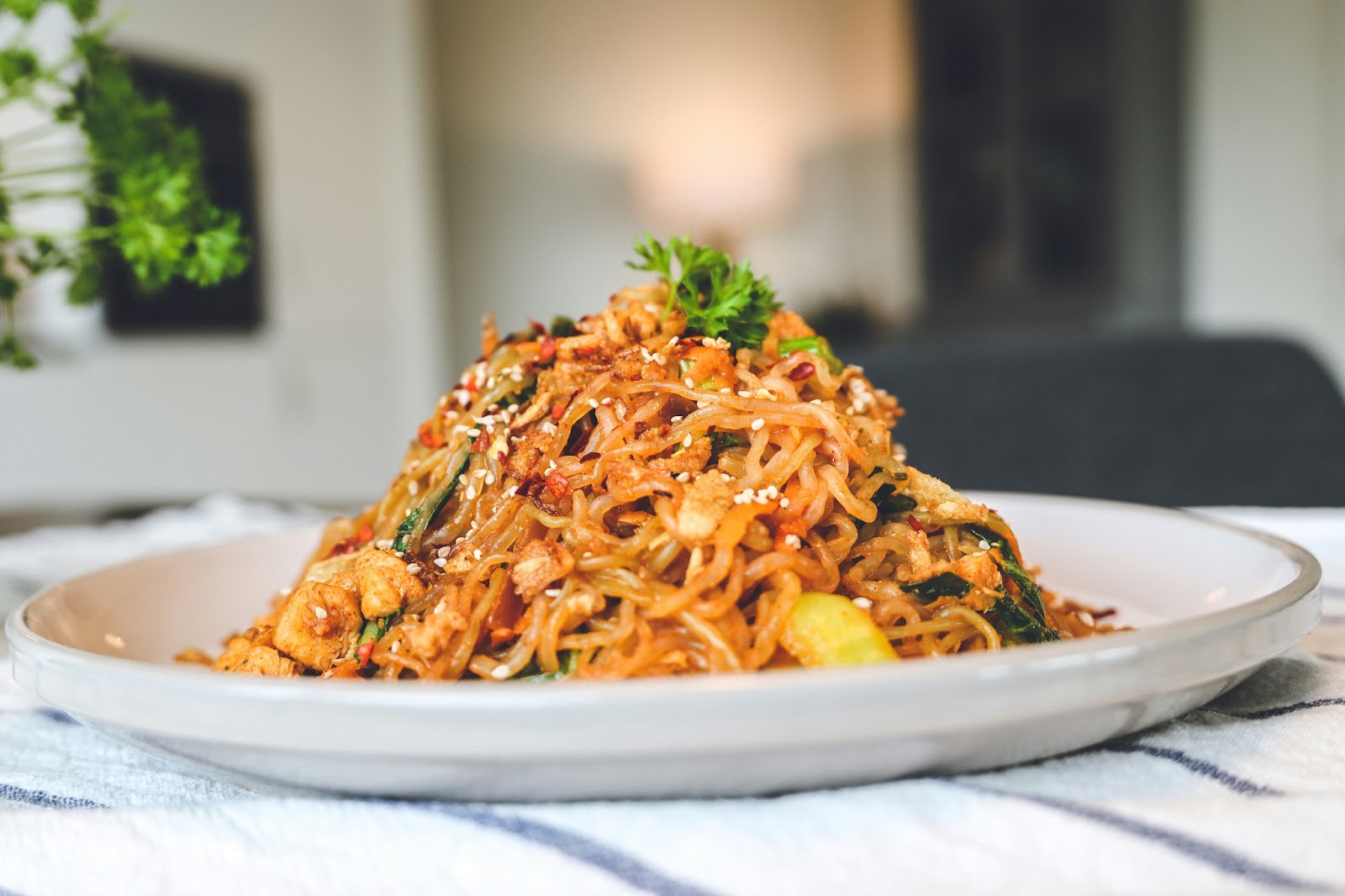 Vibrant street food culture of Bangkok prepares dishes like Pad Thai, a harmonious blend of stir-fried noodles, peanuts, lime, and chili. 