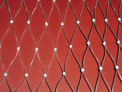 A close-up of a wire fence

Description automatically generated