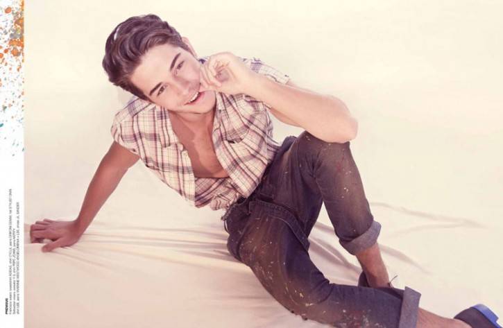 francisco lachowski with his tongue sticking out and his finger in his mouth wearing button shirt showing off his torso and chest in jeans and dress shoes