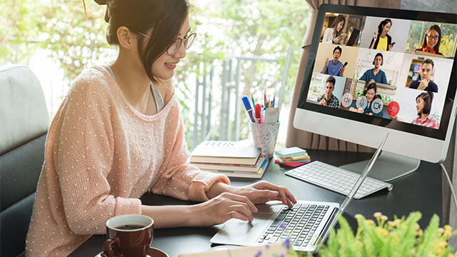 female office worker working from her home with her coworkers on video chat