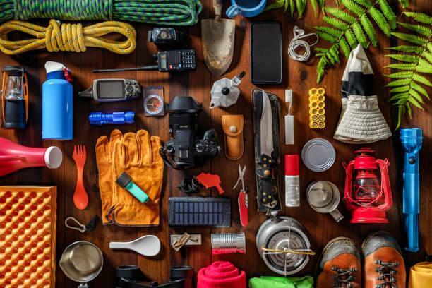 Top view camping and hiking travel and hiking gear, equipment and accessories for mountain trips Camping and hiking themes: Top view of large group of gear, equipment and accessories for mountain trips. outdoor gear stock pictures, royalty-free photos & images