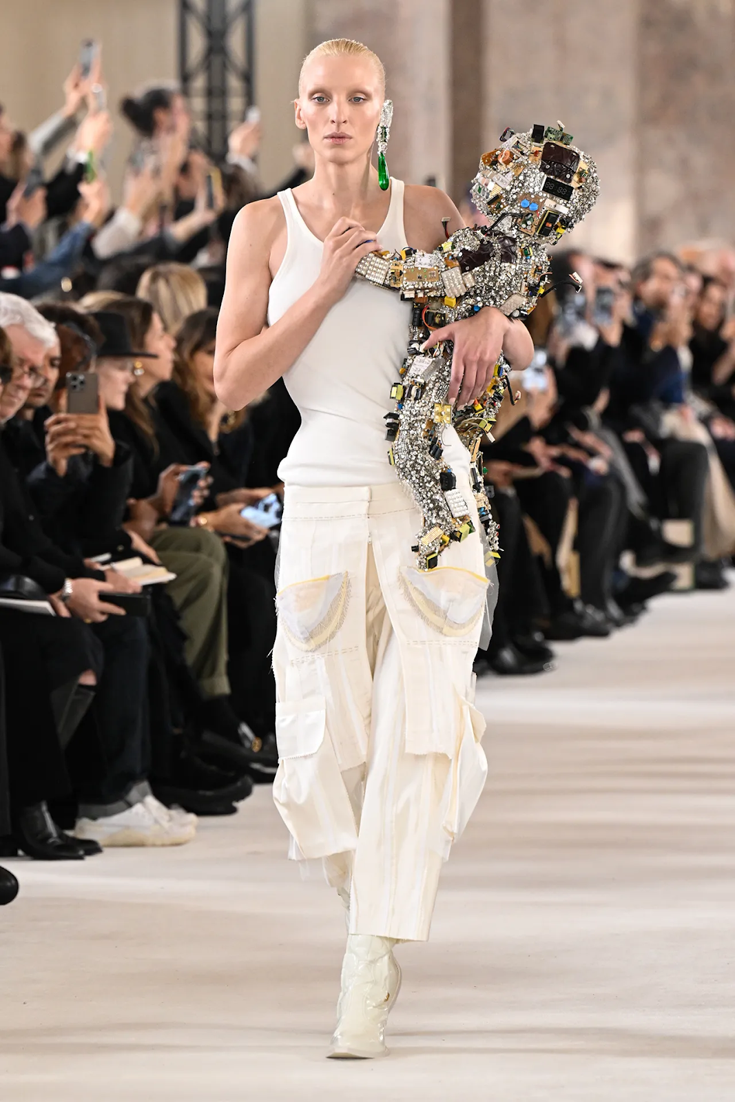 Picture of a model walking the runway with an AI baby at the Schiaparelli show