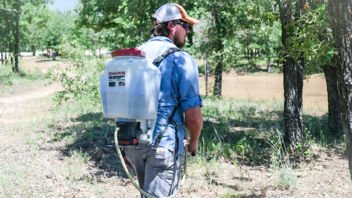 biologist with backpack sprayer