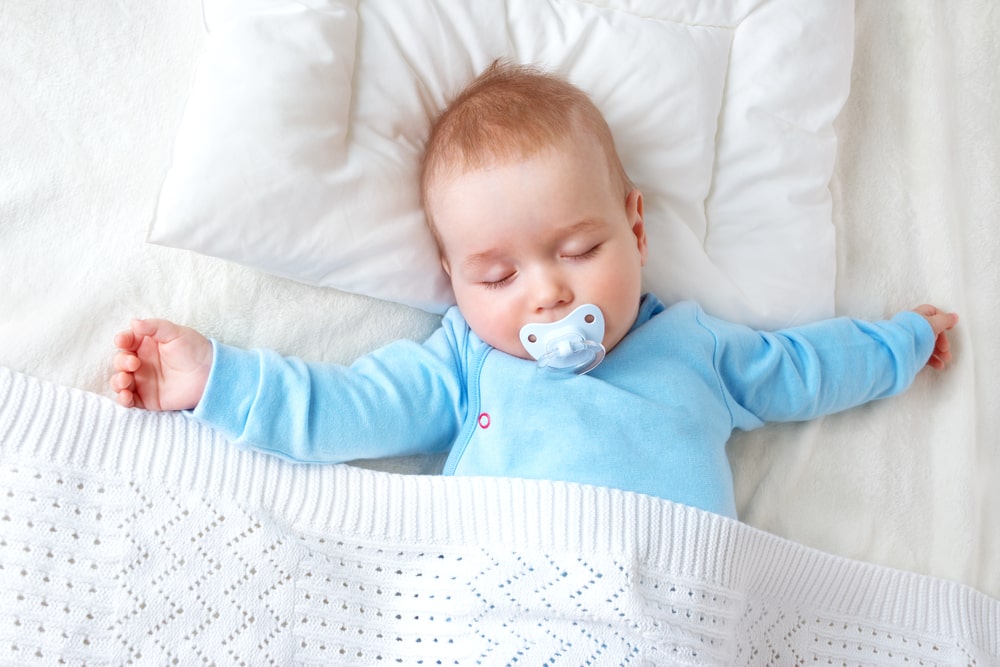 baby sleeping with pacifier in mouth 