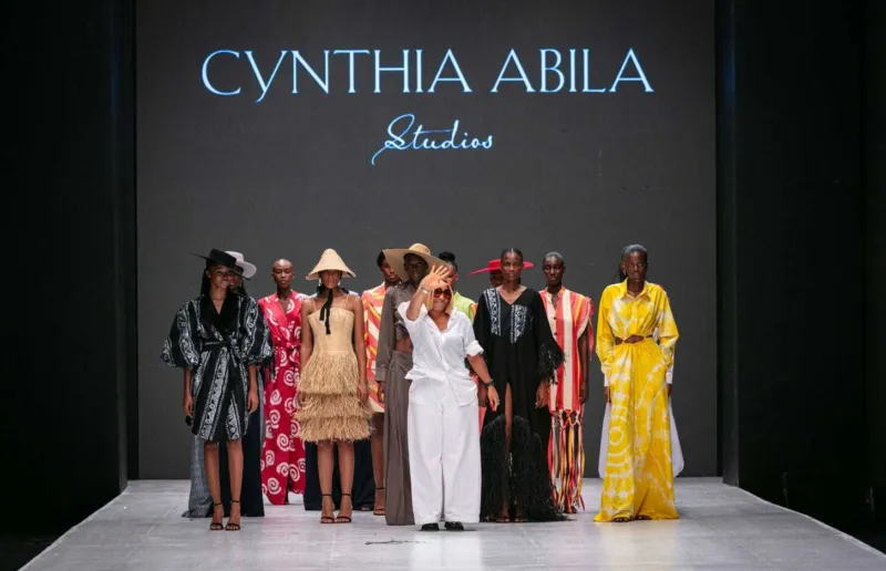Cynthia Abila standing with models while presenting her SS24 collection