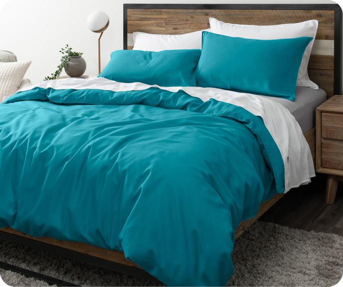 Our vibrant blue Hemp Touch Duvet Cover in Lake Blue shown on a bed with coordinating pillowcases.