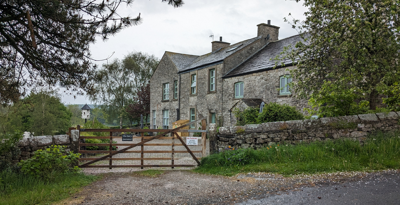 A stone house with a gate

Description automatically generated