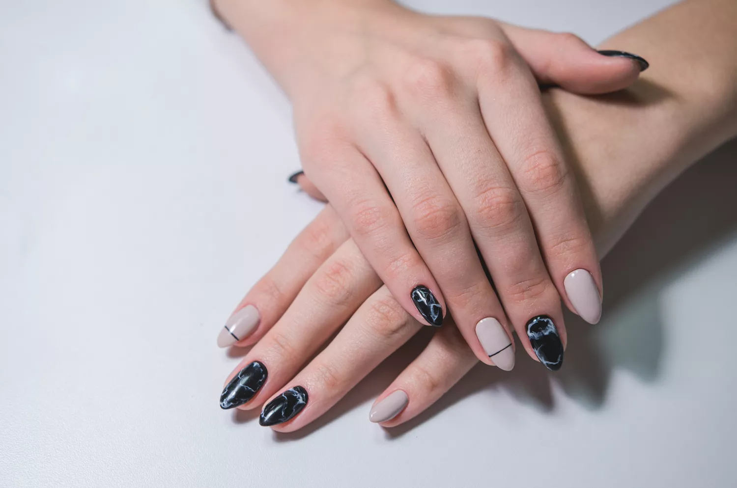 Picture showing a mix matched  nail design of the iconic nail trend