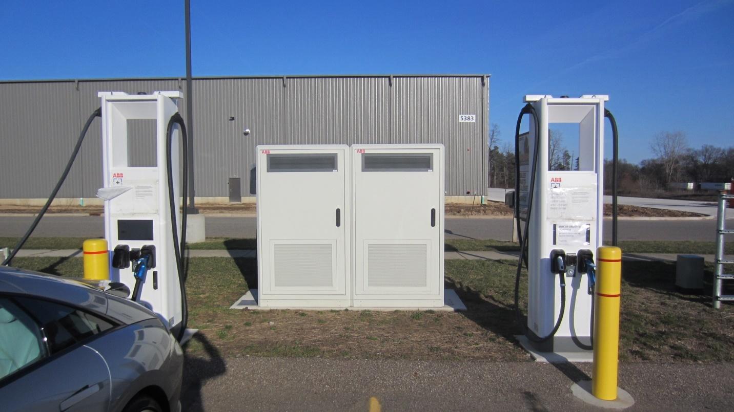 A white electrical boxes next to a car

Description automatically generated