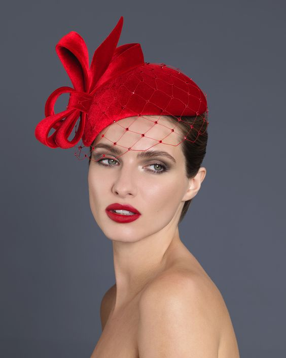 Picture showing a lady rocking a red fascinator hat