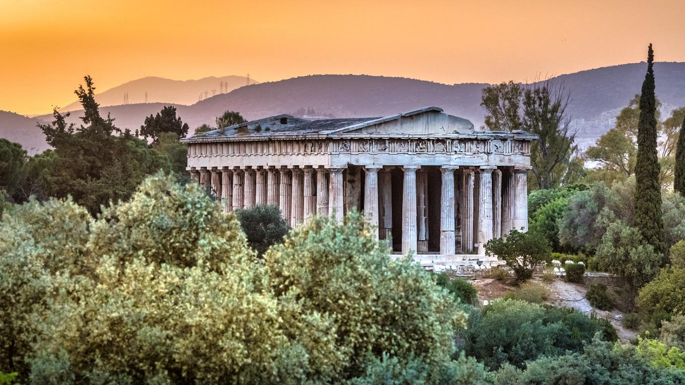 A building with columns in the middle of trees

Description automatically generated